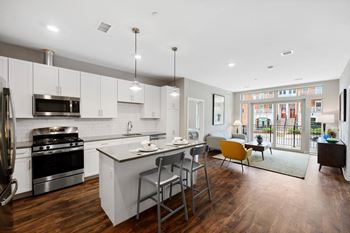 an open kitchen and living room with a table and chairs